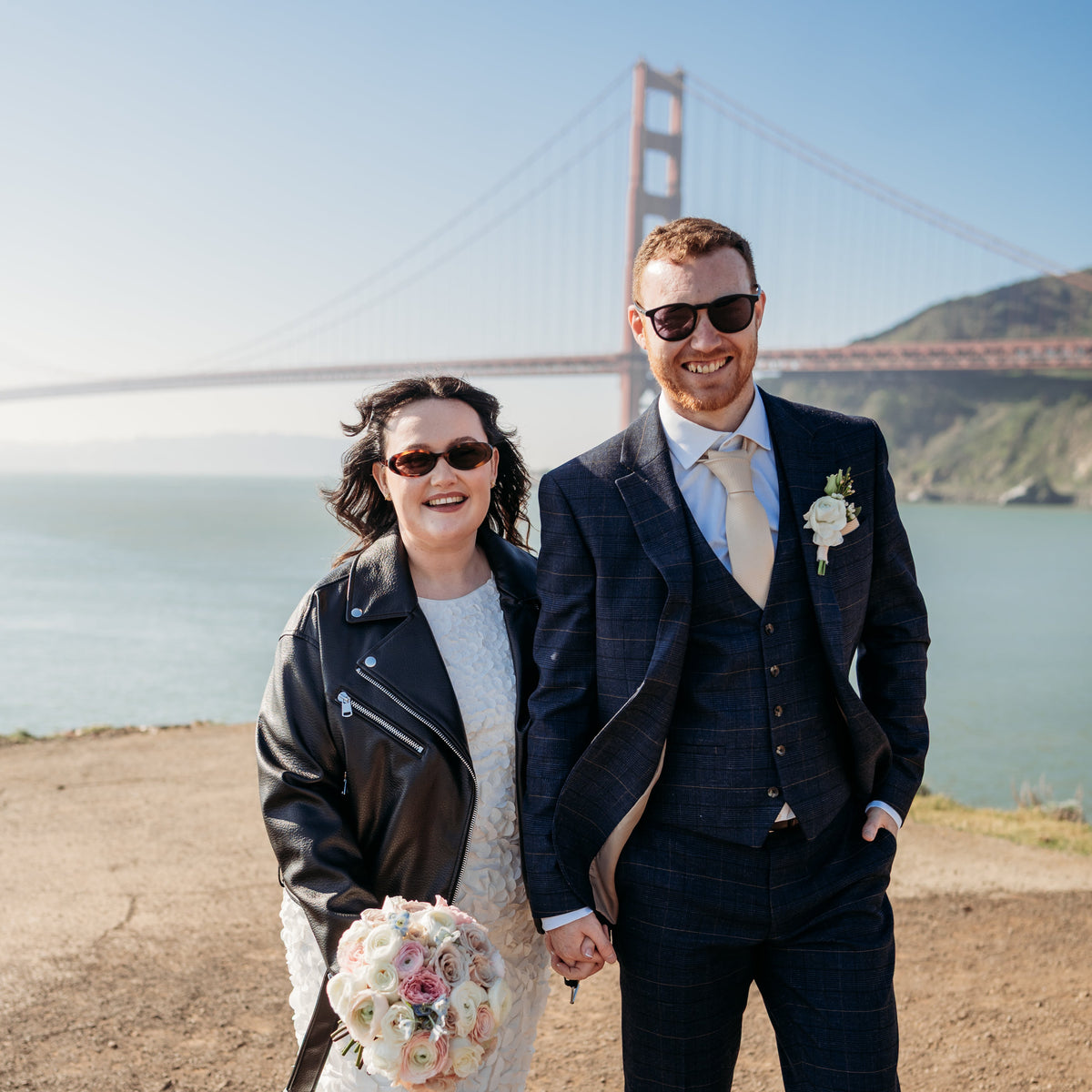 Couple in wedding attire standing in front of the Golden Gate Bridge for San Fransisco wedding elopment 