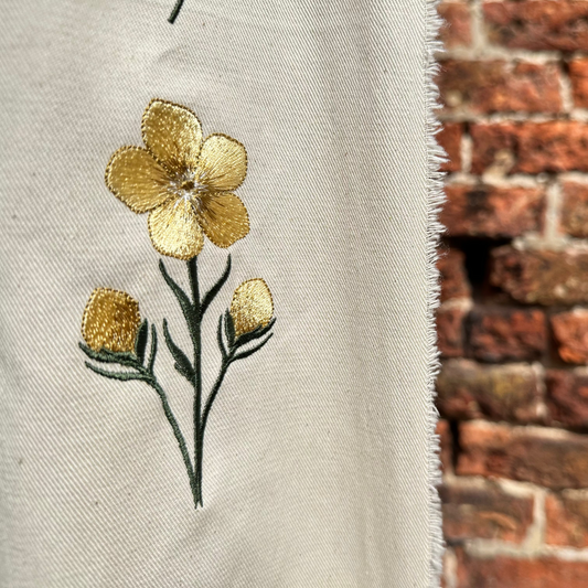 Beautiful Machine embroidery file of a buttercup flower with two buds.