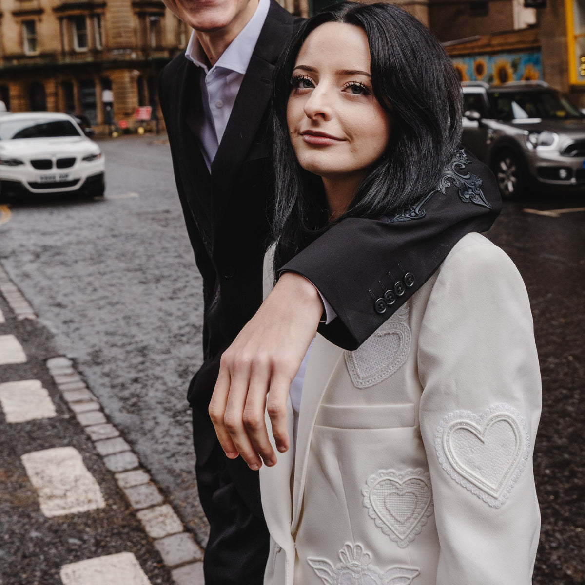 Modern white bridal suit adorned with intricate heart embroidery and artisanal hand beading, designed for personal expression.