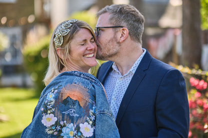 Bride wearing a custom embroidered mountain floral light blue denim jacket by Beth Wilson Embroidery